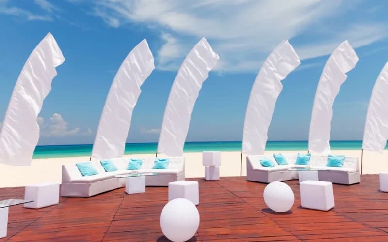 A sundeck with chairs and flags at Playacar Palace.
